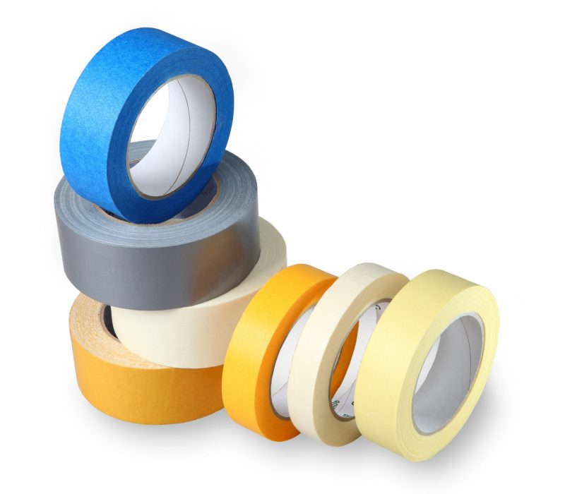Seven coils colored adhesive tape on paper and polymer-based, isolated image on a white background, horizontal arrangement with painted shade.